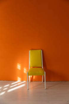 Yellow Vintage Chair Against Orange Wall