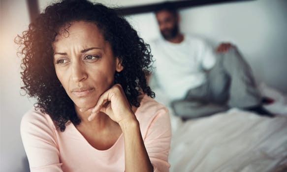 Divorce, sad and couple in bedroom for problem, depression and marriage fail and mental health risk. Thinking, fight and woman with man, conflict and home depressed with anxiety, frustrated or stress