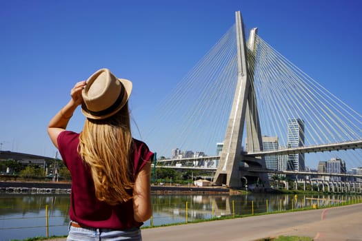 Tourism in Sao Paulo. Back view of traveler girl enjoying sight of Estaiada bridge in Sao Paulo, Brazil.