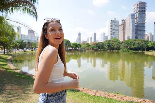 Portrait of cheerful Brazilian girl in Vaca Brava Park in Goiania, Goias, Brazil