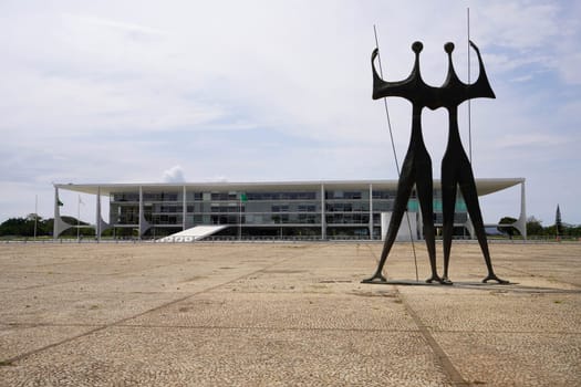 BRASILIA, BRAZIL - AUGUST 30, 2023: Os Candangos sculpture in front of Palacio do Planalto the official workplace of the president of Brazil in Brasilia