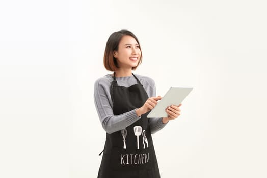 Woman in apron using tablet