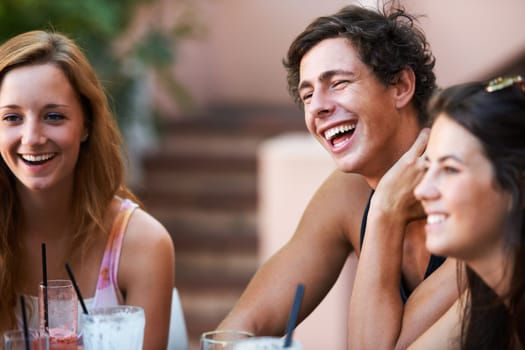 Friends, people and relax with laughter at restaurant, bonding and social gathering with happiness outdoor. Comedy, together and fun at diner, young man and women having drinks with communication