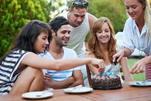Birthday, friends and cutting cake outdoor for celebration, surprise or party with milestone or happiness. Dessert, men and women in backyard of home with gathering or social event with smile and fun