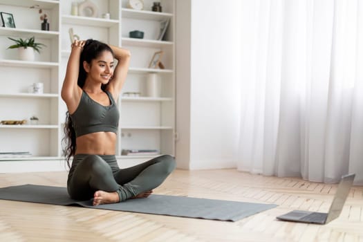 Woman Stretching Up In Front Of Laptop, Doing Home Workout