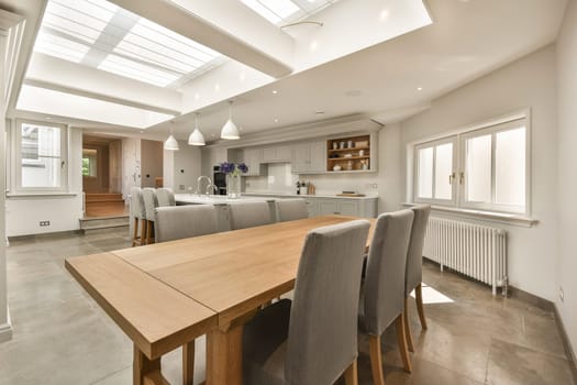 a large dining room and kitchen with a wooden table
