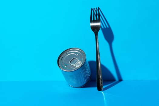Tin can with food on blue background
