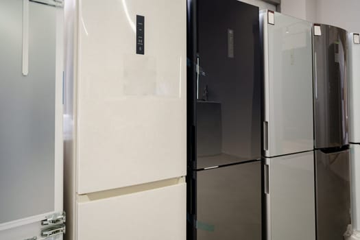 Row of fridges in household appliances store
