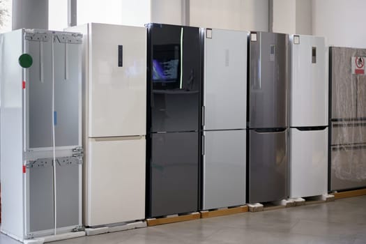 Row of fridges in household appliances store