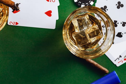 Cuban cigar, whiskey glass and chips on table