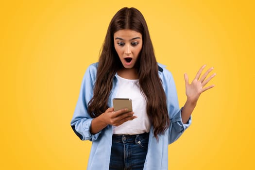Shocked teen student lady with smartphone, has good news, win message