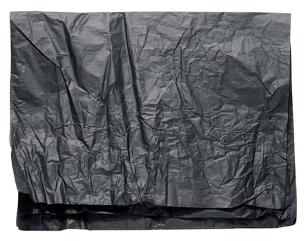 Folded sheet of crumpled black parchment paper on white isolated background