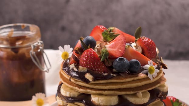 Pancakes with fruits and chocolate sauce