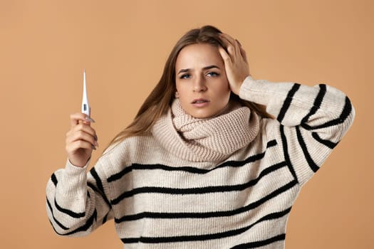 woman with high fever measuring body temperature by thermometer