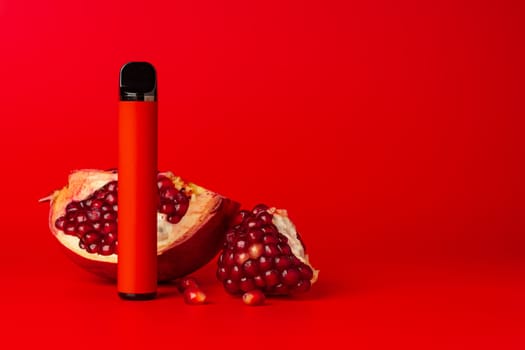 Electronic cigarette with pomegranate flavor on red background