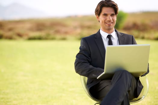 Portrait, laptop and businessman on chair in nature, typing email online on pc or remote work outdoor on mockup space. Computer, smile or professional lawyer in countryside on technology to freelance