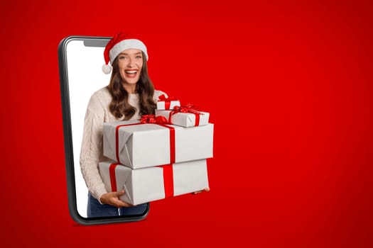 Happy Woman In Smartphone Holding Xmas Presents On Red Background
