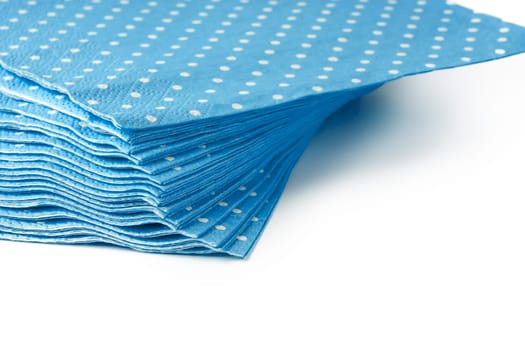Stack of blue dotted paper napkins isolated on white