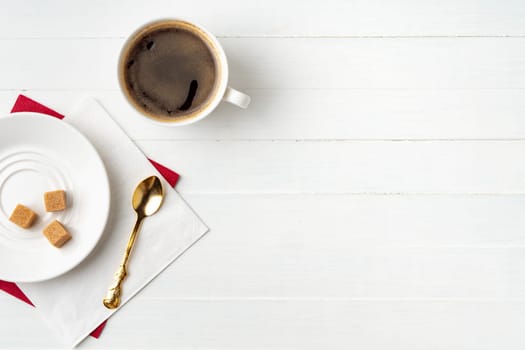 Top view of coffee cup and paper napkins on wooden background