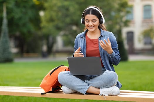 Young indian woman student have online class, chilling at park