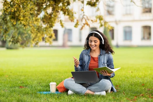 Young Eastern Woman Study Outdoors With Laptop And Headphone