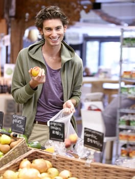 Man, portrait and fruit shopping in grocery store for fibre nutrition, vegan food and healthy choice. Male person, smile and peach bag supermarket for organic health diet, vitamins or happy customer