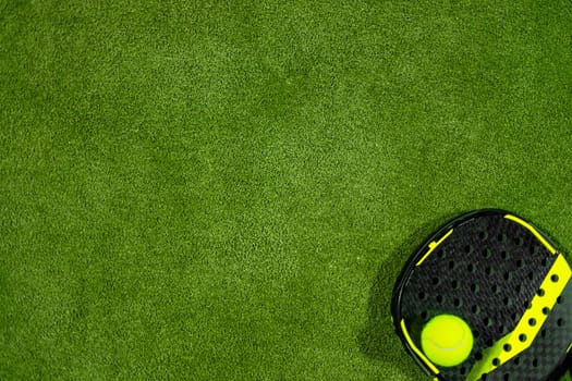 Padel tennis racket. Background with copy space. Sport court and ball.