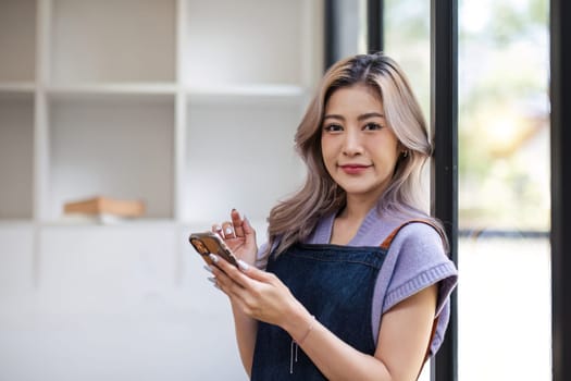 Startup small business entrepreneur SME asian woman receive order on phone. Success young Asian small business owner home office, online sell marketing delivery SME e-commerce telemarketing concept
