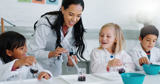 Science, education and children in a classroom with their teacher for learning or to study chemistry. Kids, school and scholarship with students in lab class for an experiment of chemical reaction