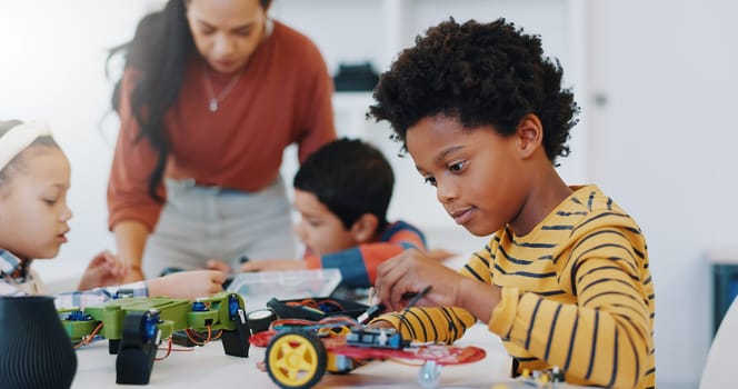 Technology, boy and car robotics at school for learning, education or electronics with car toys for innovation. Classroom, learners and transportation knowledge in science class for research or study