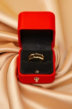 Golden ring in red jewelry box close up