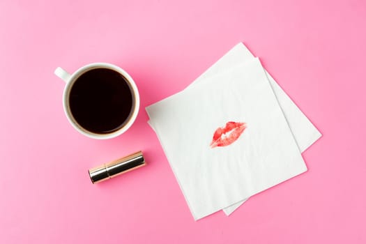 Coffee cup with paper napkins on pink background