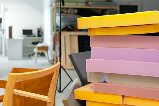 Stacked sheets of foam rubber for furniture production in factory workshop