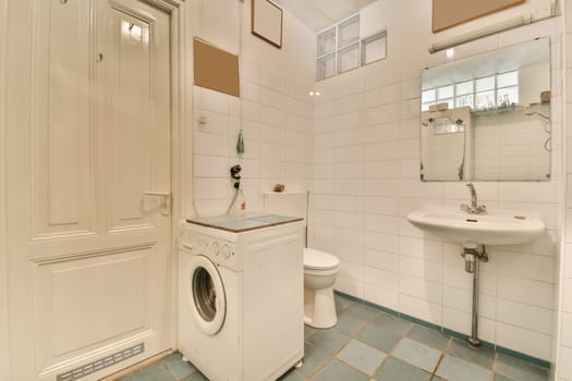 a bathroom with a washing machine and a sink