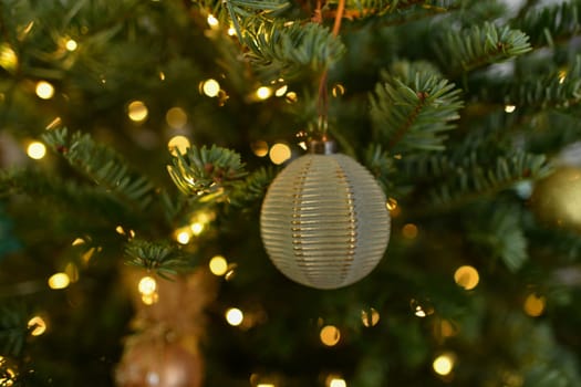 Green ball Christmas toys hanging on the tree