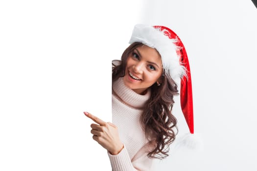 Girl in Christmas hat holding poster