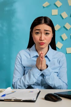 Woman praying for better working conditions