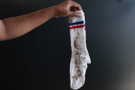 men dirty socks on black background