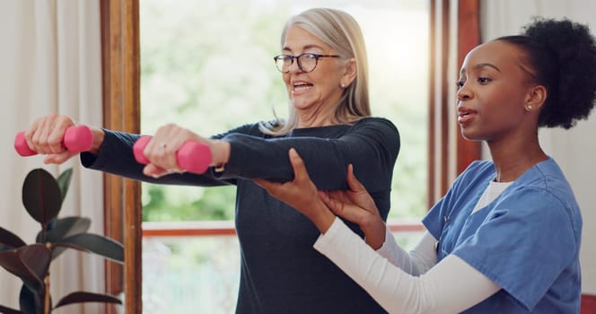 Physical therapy, exercise and senior woman with dumbbell, weightlifting and training arms and muscle. Strong, fitness and old person with nurse or physiotherapist to help in rehabilitation workout