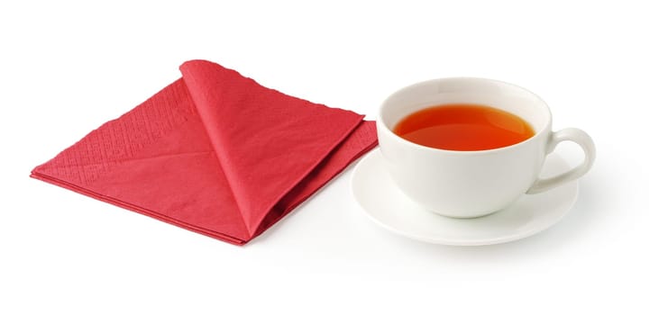 Cup of tea and paper napkin on white background