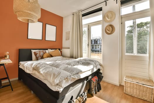 a bedroom with orange walls and a bed with blankets