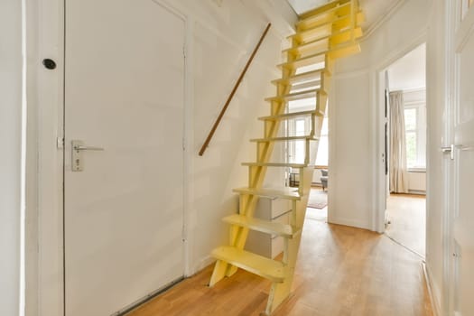 a yellow ladder in a white room with a door