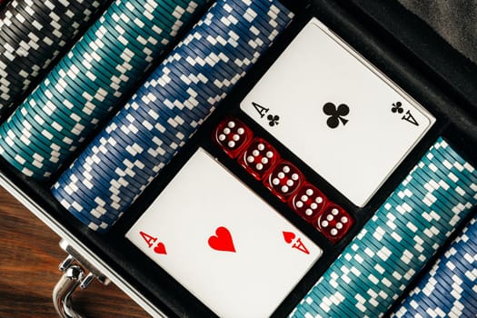 Playing cards and chips in a case on wooden table