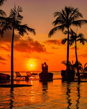 Man and Woman relaxing in a swimming pool, a couple on a honeymoon vacation in Mauritius
