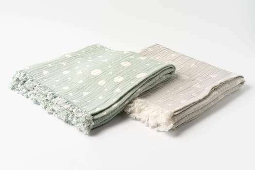 Gray and green muslin blankets on white background