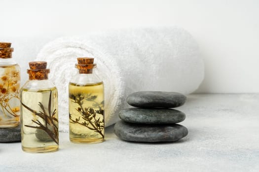 Organic essential aroma oil with herbs and towels, spa relax concept