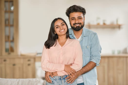 Young Hindu spouses embracing in a cozy home setting