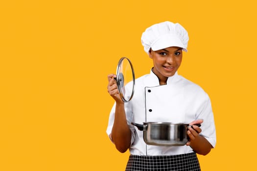 Nice Recipe. Happy Black Chef Woman Opening Saucepan And Smiling At Camera
