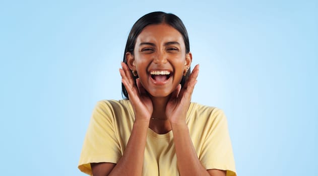 Excited, woman and portrait with wow, surprise and winner with a smile in a studio. Blue background, happy and celebration with female person with motivation from announcement and achievement.