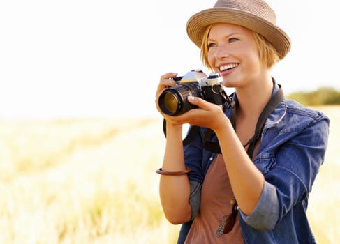 Field, photographer and woman with a camera, adventure and thinking with ideas, nature and memory. Person, countryside and girl with photography, tourism and journey with sunshine, smile and travel.